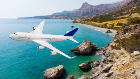 Airplane landing above beautiful beach and sea backgroundの写真素材