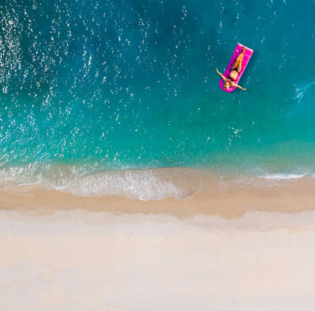 Woman on air mattress in the sea. Young woman on air mattress in the sea.の写真素材