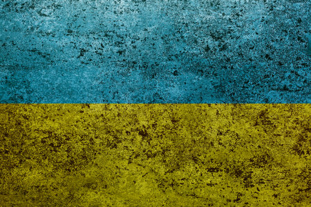 Flag of Ukraine on old grunge wall in background
