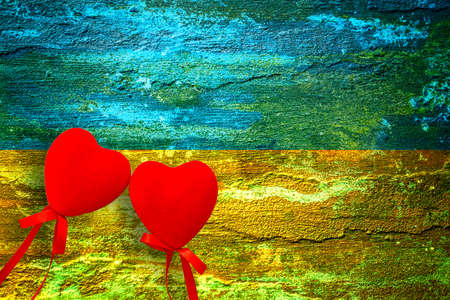 The concept of ending the war in Ukraine. hearts on the background of the flag of ukraineの写真素材