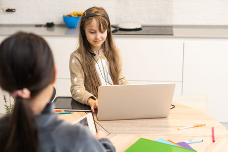 two schoolgirls studying at home