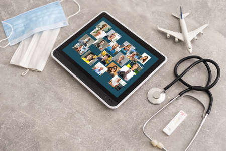 international medical travel insurance concept, digital tablet with stethoscope, airplaneの写真素材