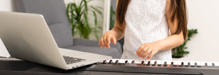 a little girl learns to play the synthesizer. learning to play musical instruments.