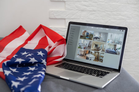 american or usa national flag. working from home on computer notebook laptop on webcam video call conference in quarantine.の写真素材