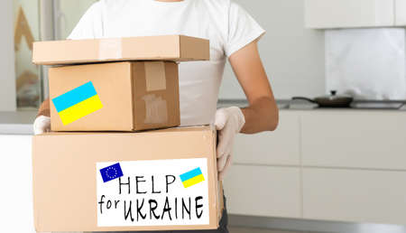 Volunteers collecting donations for the needs of Ukrainian migrants, humanitarian aid concept.の写真素材