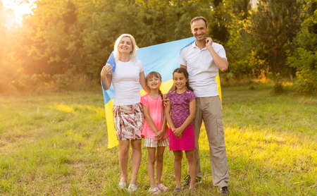 Ukraines Independence Flag Day. Constitution day. family with the flag of ukraine in field. 24 August. Patriotic holiday.の写真素材