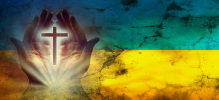 Hands in prayer. Prayer for Ukraine. Ukrainian flag. Prayer for the whole worldの写真素材
