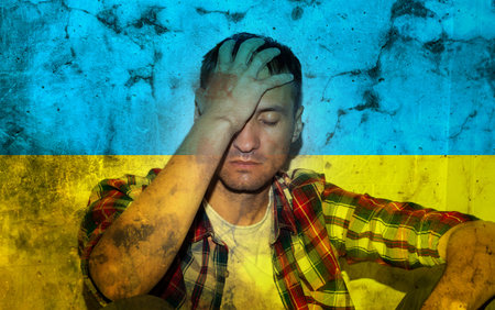 Double exposure of depressed mature man, alone in darkness, stop the war concept and Ukrainian flag