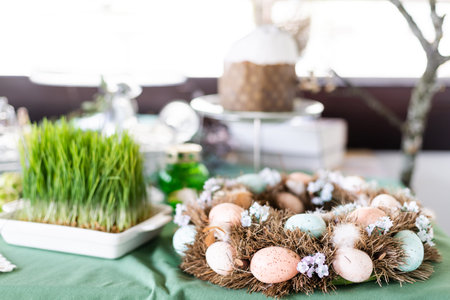 easter basket with easter eggs on wooden background