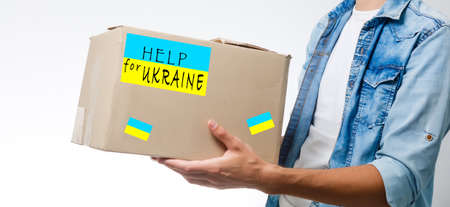 a man holds a box with humanitarian aid to ukraineの写真素材