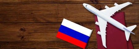 Russian flag, toy plane and barbed wire on background, concept of banning aircraft departing from Russiaの写真素材