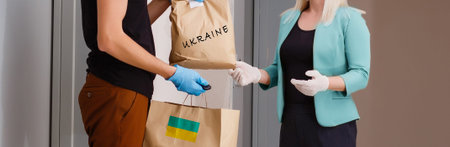 a man holds a box with humanitarian aid to ukraine