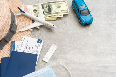 Syringe, toy plane, medical mask and passport with certificate of vaccination with text Covid-19...