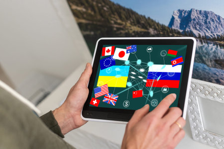 Ukrainian and Russian flags placed on a map on the tablet. Ukraine crisis and Conflict.