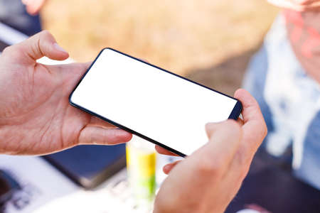 young boy who is playing online games in his mobile phoneの写真素材