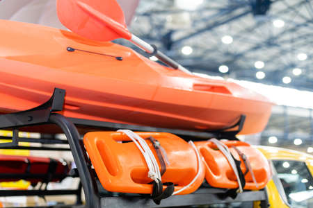 Orange lifeboat on display, paddle.の写真素材