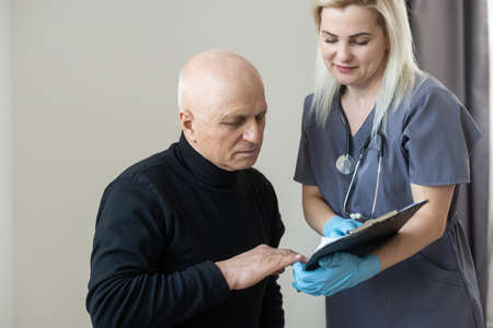 Portrait of smiling mature male patient feel excited about good quality service in private hospital. Happy senior 60s man satisfied with consultation in clinic. Elderly healthcare, geriatric conceptの写真素材