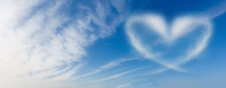 blue sky with hearts shape clouds. Beauty natural backgroundの写真素材