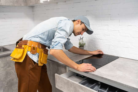 Installation of induction stove or cooktop by a master.の写真素材