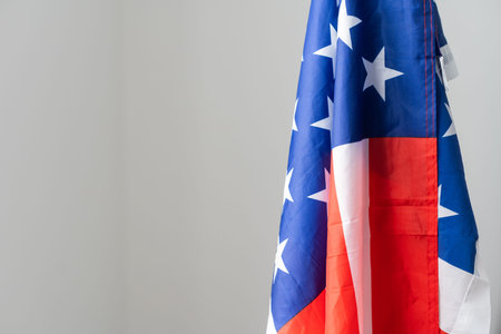 Closeup of American flag on plain background