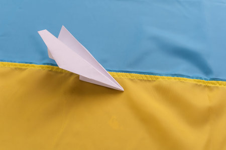 paper airplane on the background flag of Ukraine, flags of the country, blue, yellowの写真素材