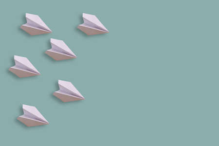 six paper airplanes isolated on a blue backgroundの写真素材