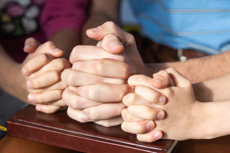 children praying with parent at home, family pray together, online group worship, World Day of Prayer,international day of prayer, hope, gratitude, thankful, trustの写真素材