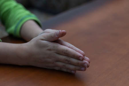 Childs hands folded together in prayerの写真素材