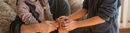 Hands of the old man and a childs hand.