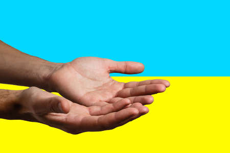 Pray for ukraine. hands pray on ukraine flagの写真素材