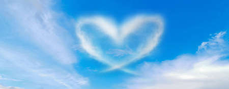 blue sky with hearts shape clouds. Beauty natural backgroundの写真素材