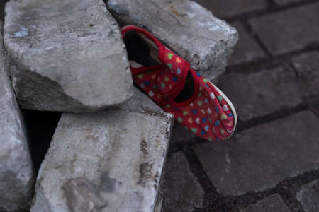 Kids shoes on representing civilian casualties in an active war zoneの写真素材