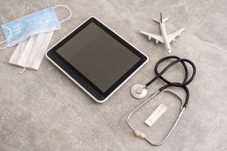 Medical equipment: stethoscope and tablet on grey backgroundの写真素材