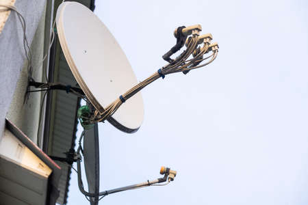 satellite dish and television antenna on roof topの写真素材