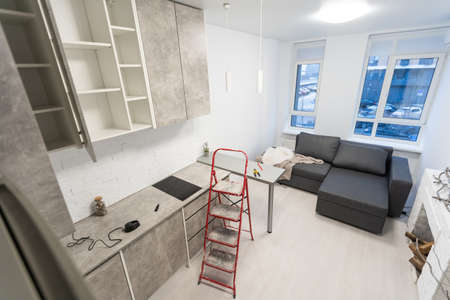 Renovated kitchen interior with stylish furniture and maintenance equipmentの写真素材