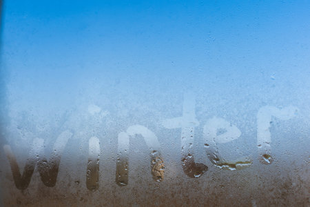 word winter written on a foggy window
