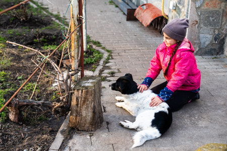 Cute smiling Little girl hugging dog.