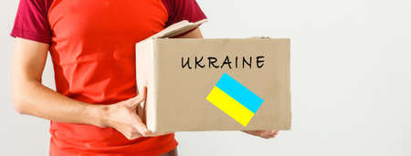 a man holds a box with humanitarian aid to ukraineの写真素材