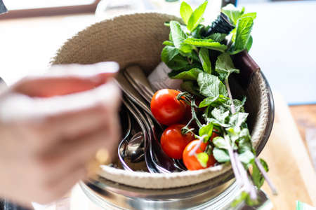 Cherry tomatoes with basil on wooden table close upの写真素材
