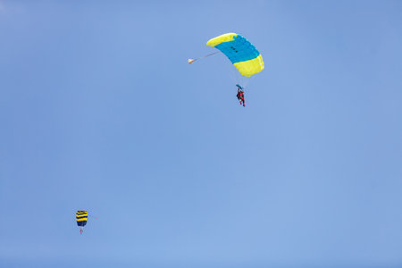 Skydiver with a little canopy of a parachute on the background a blue sky, close-up. Skydiver under parachuteの写真素材
