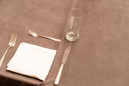 fork and knife on a napkin on the table