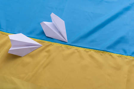 Two paper airplanes with the flag of Ukraine. Handmade arts conceptの写真素材