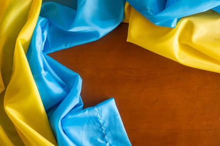 Ukraine flag on wooden table backgroundの写真素材
