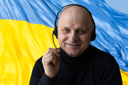 Happy young man on the background of the flag of Ukraine.