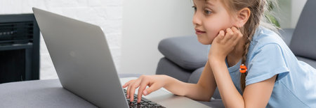little girl studying with computer, little girl with laptop online.