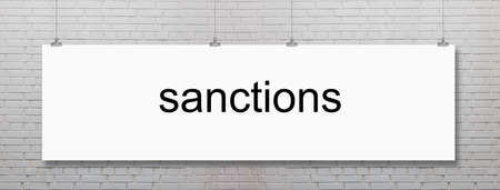 The word sanctions is written on notebook. Political and economic conceptの写真素材