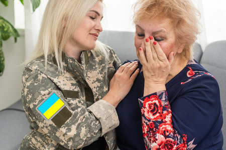 Soldier woman reunited with her motherの写真素材