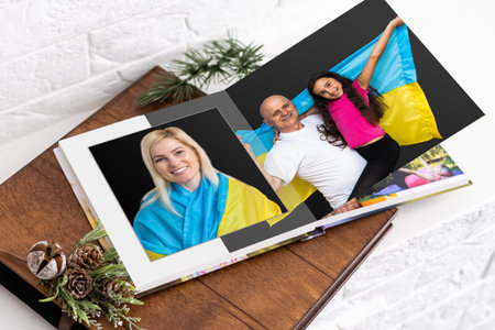 on white table open photobook from photo shoot of family with ukraine flag