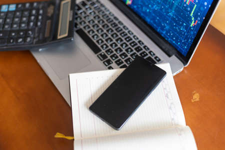 The report summarizes the results of business operations, laptop computer, calculator on desk of investor. top view.の写真素材