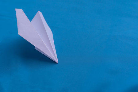 Paper airplane on a blue backgroundの写真素材